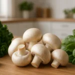 Fresh mushrooms displayed on a wooden table with other keto diet vegetables, showing low carb vegetables suitable for keto