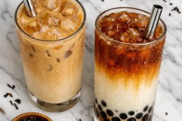 milk tea recipe two glasses of creamy homemade milk tea with tapioca pearls and wide straws on marble
